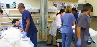 two sets of doctors looking over patients
