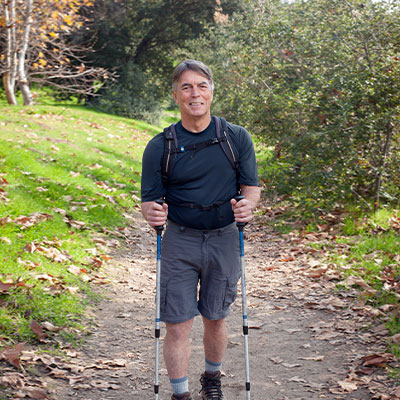 Jim Horstman walking in nature with hiking poles