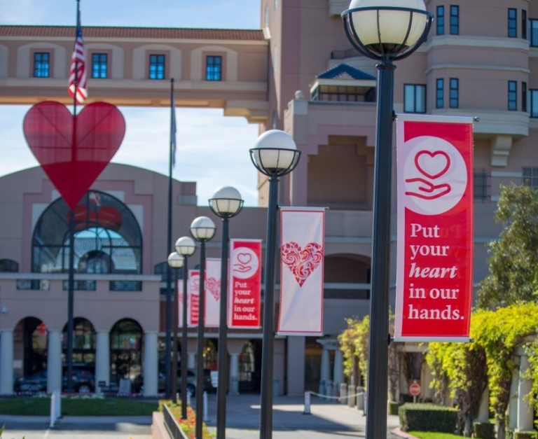 Huntington Hospital entrance with large red heart sculpture and heart health banners