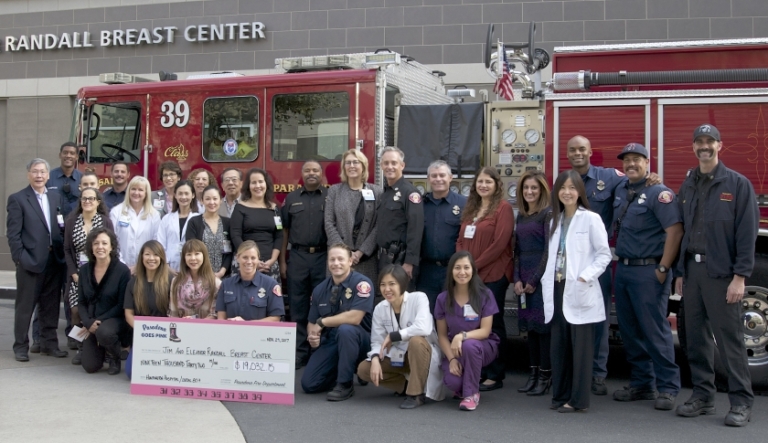 Pasadena Goes Pink donation check presentation to Jim and Eleanor Randall Breast Center with fire department and hospital staff