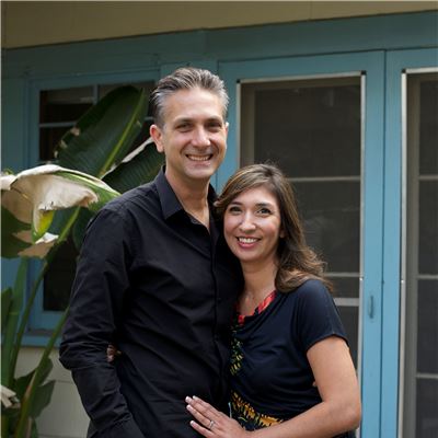 Deborah melahouris and her husband, standing outside their home