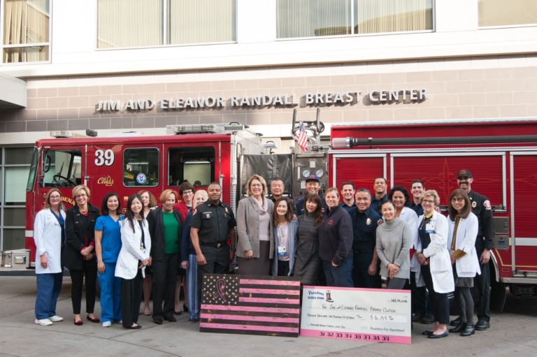 Pasadena Goes Pink donation check presentation to Jim and Eleanor Randall Breast Center with fire department and hospital staff