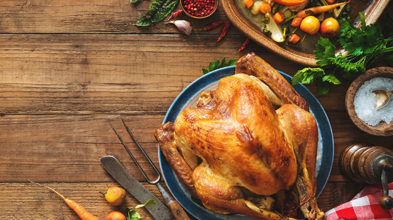 Roasted turkey with vegetables on holiday dinner table