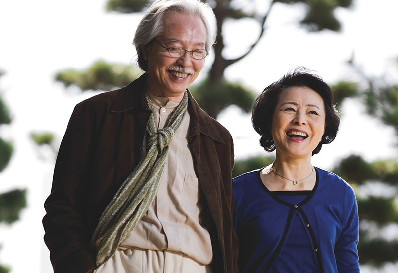 Aging In Place class - Senior asian couple laughing as they walk outside