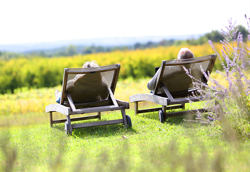 Stress management class - two people relaxing in lounge chairs outside
