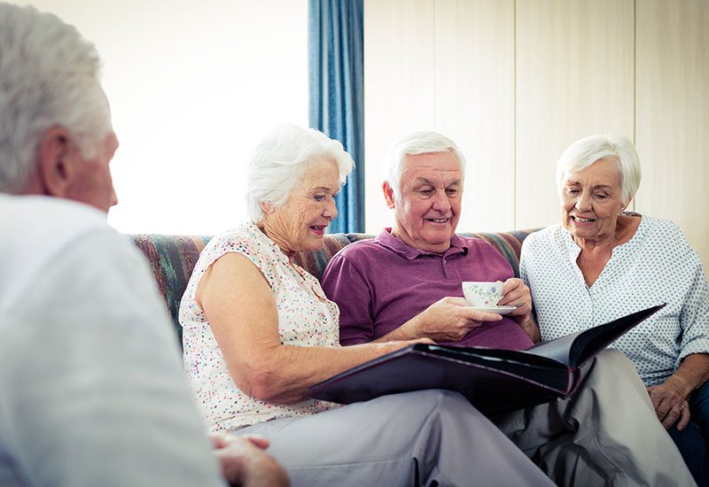 Four seniors sitting on couch and talking