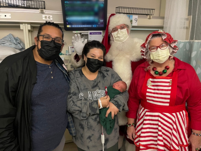Santa at the NICU with new parents and baby