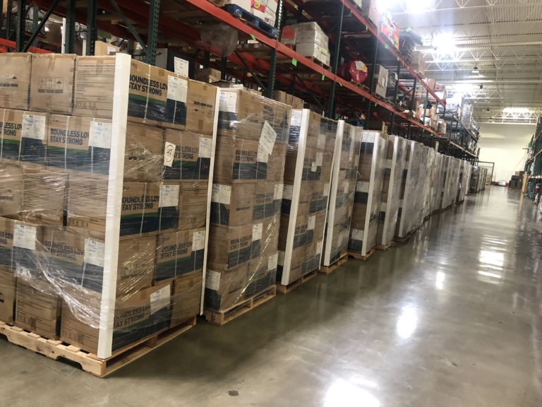 Rows of palletized medical supply boxes in a warehouse