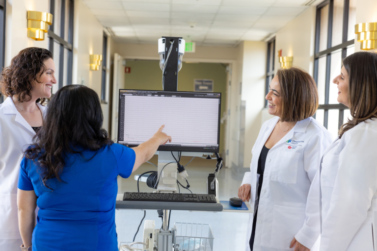 Huntington Health medical team reviewing patient data on monitor
