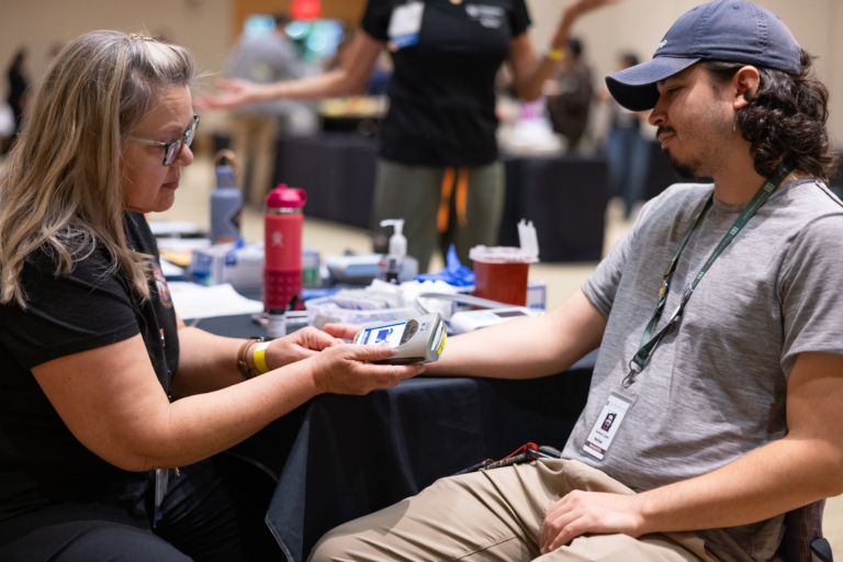 Health professional conducting a screening for a community member.